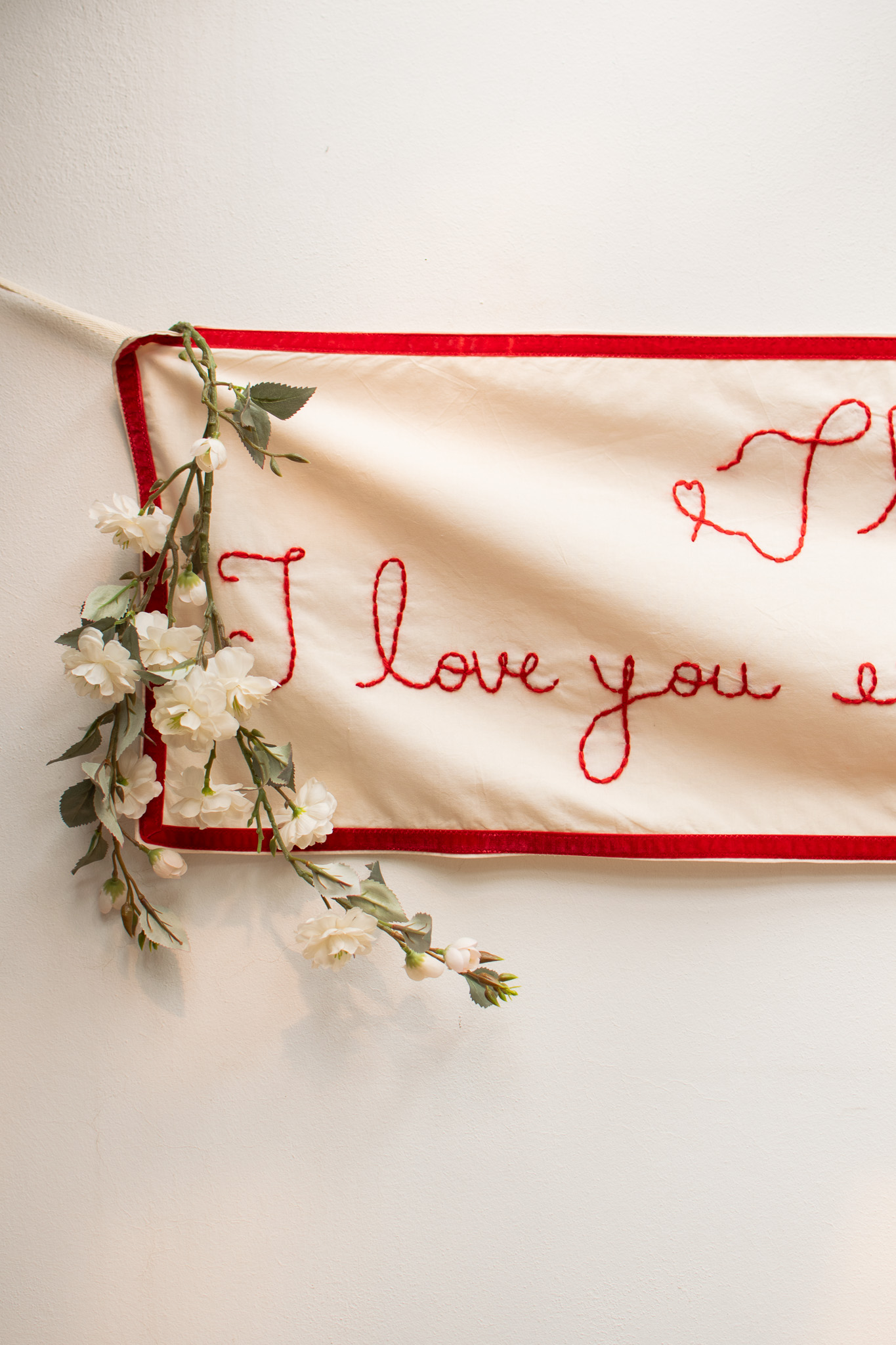 Delicate hand-embroidered botanical motifs on fine ivory fabric